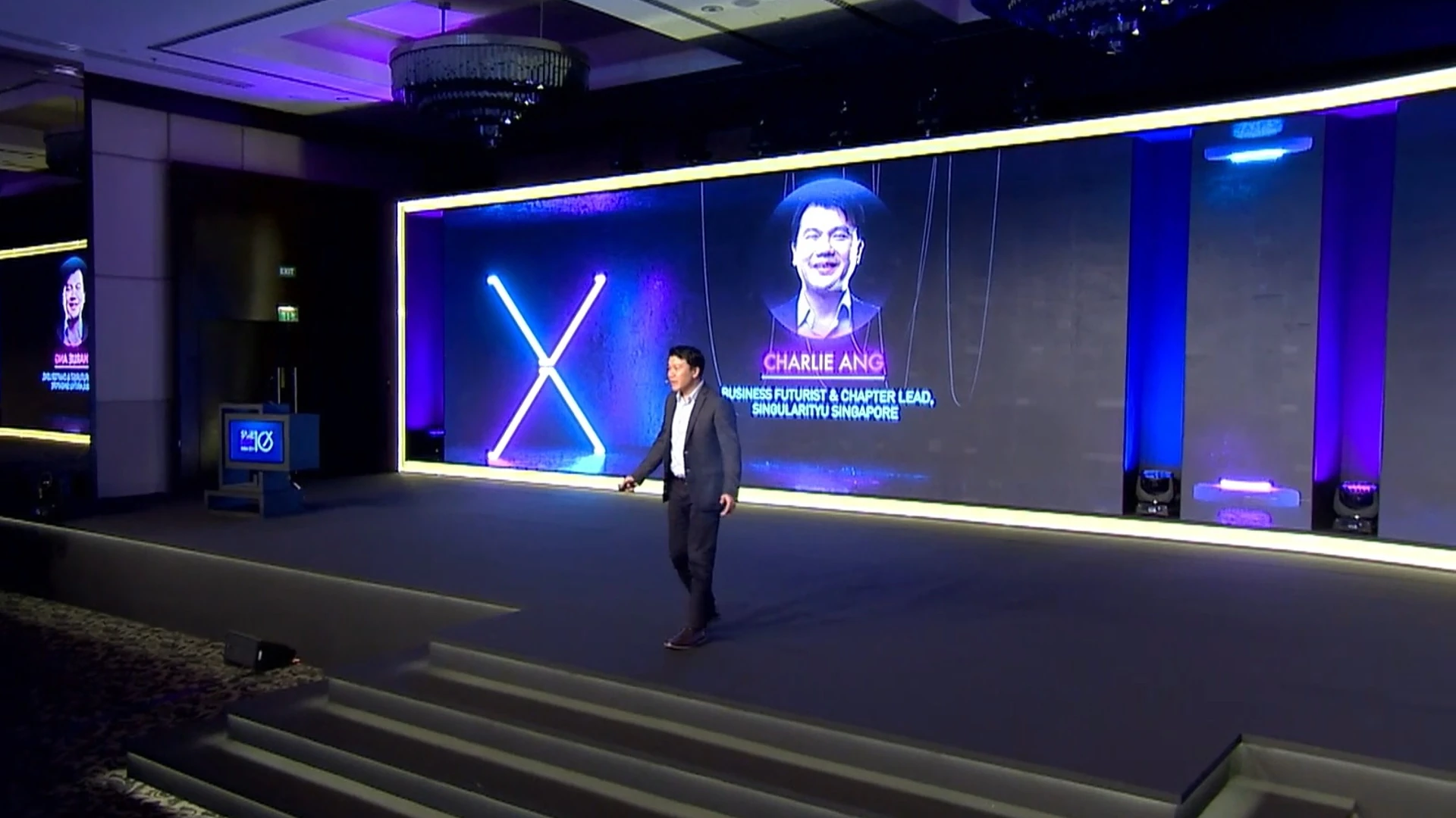 Charlie Ang speaking at a large-scale conference stage